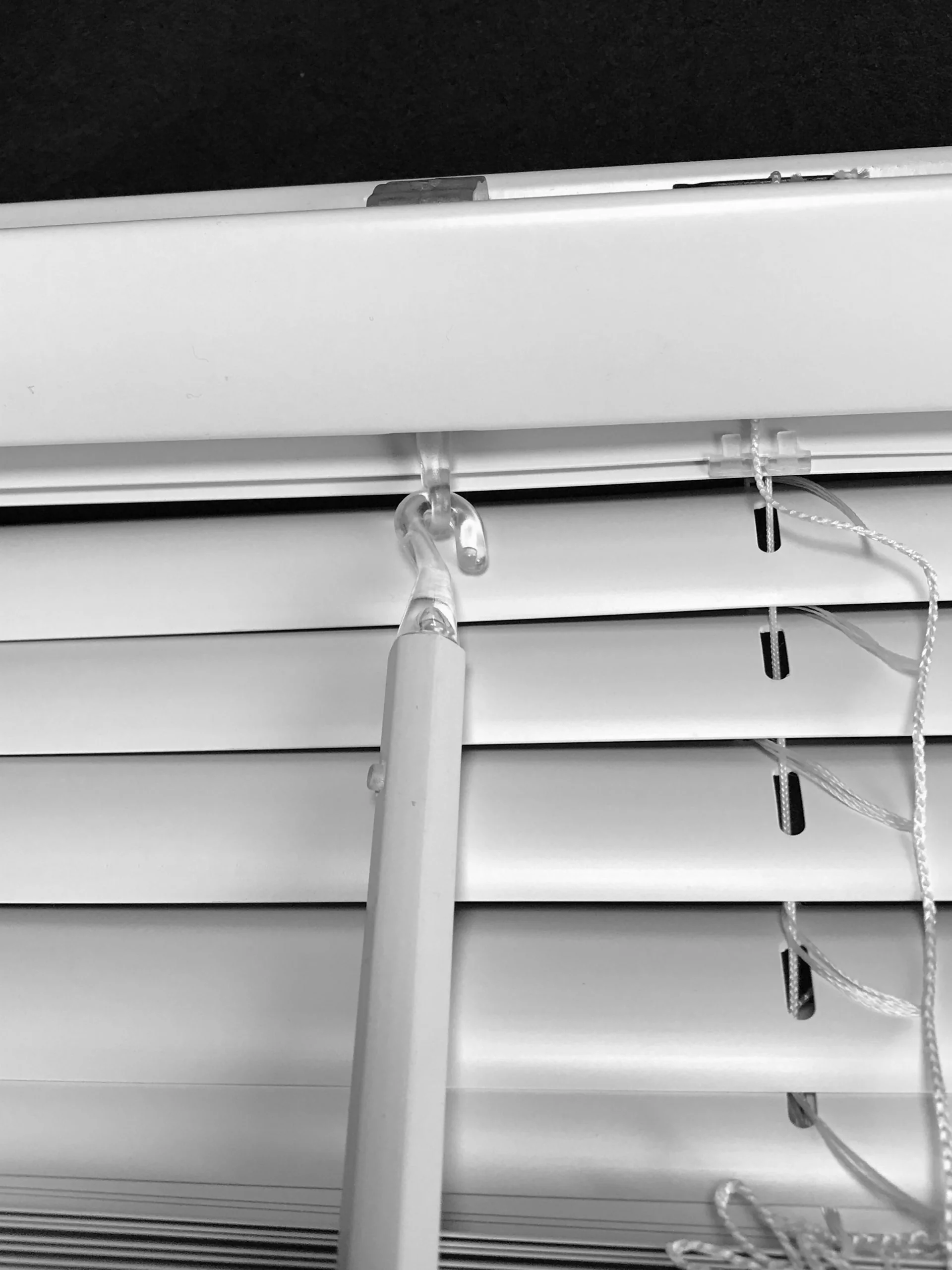Close-up of vinyl mini blind slats and headrail
