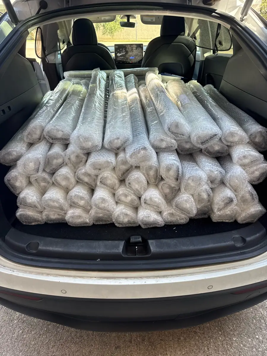 Wrapped roller shades loaded in the back of a vehicle for delivery to Eustace, TX