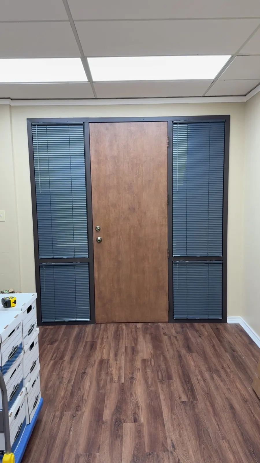 Office door with dark blinds on both sidelights, Frisco, TX