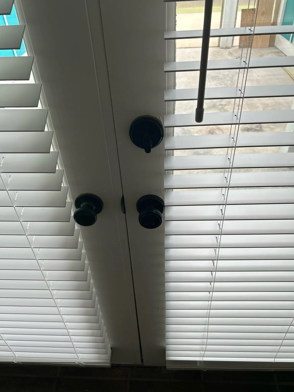 White faux wood blinds mounted on a pair of French door panels in Irving, TX
