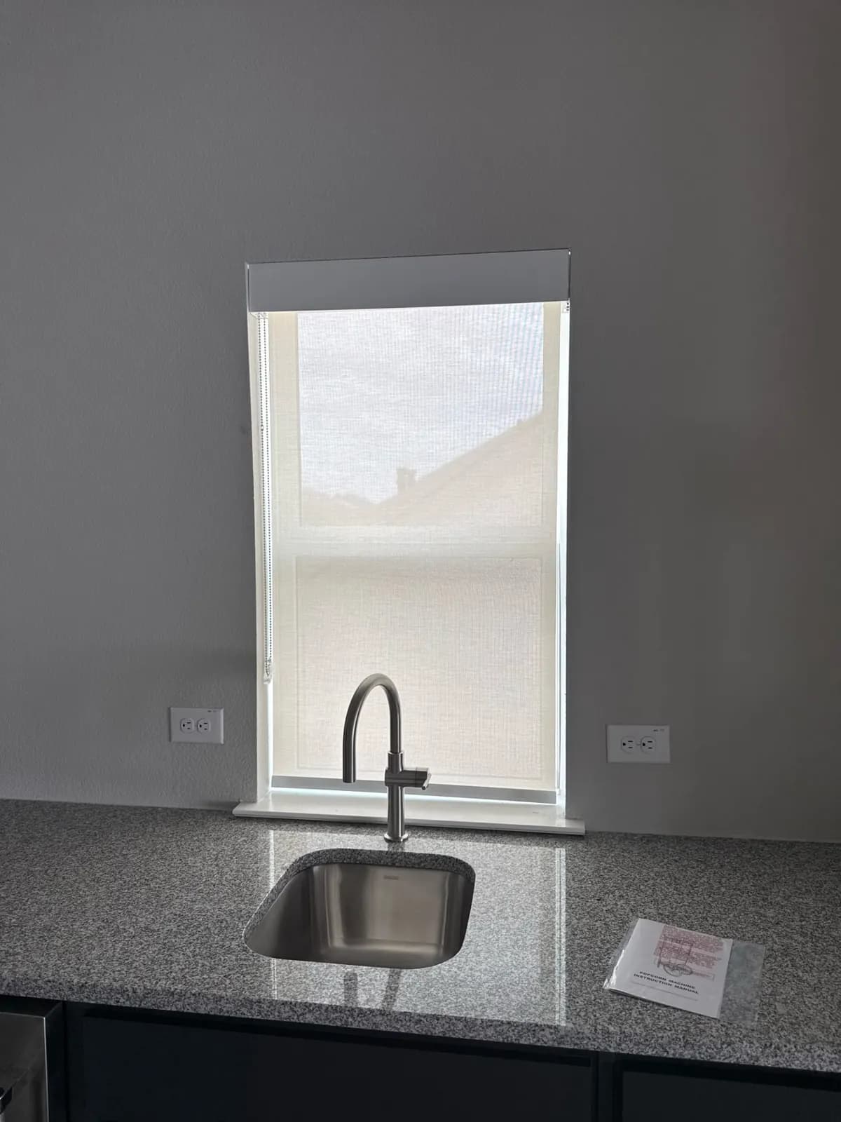 Roller shade on the window above a kitchen sink in McKinney, TX