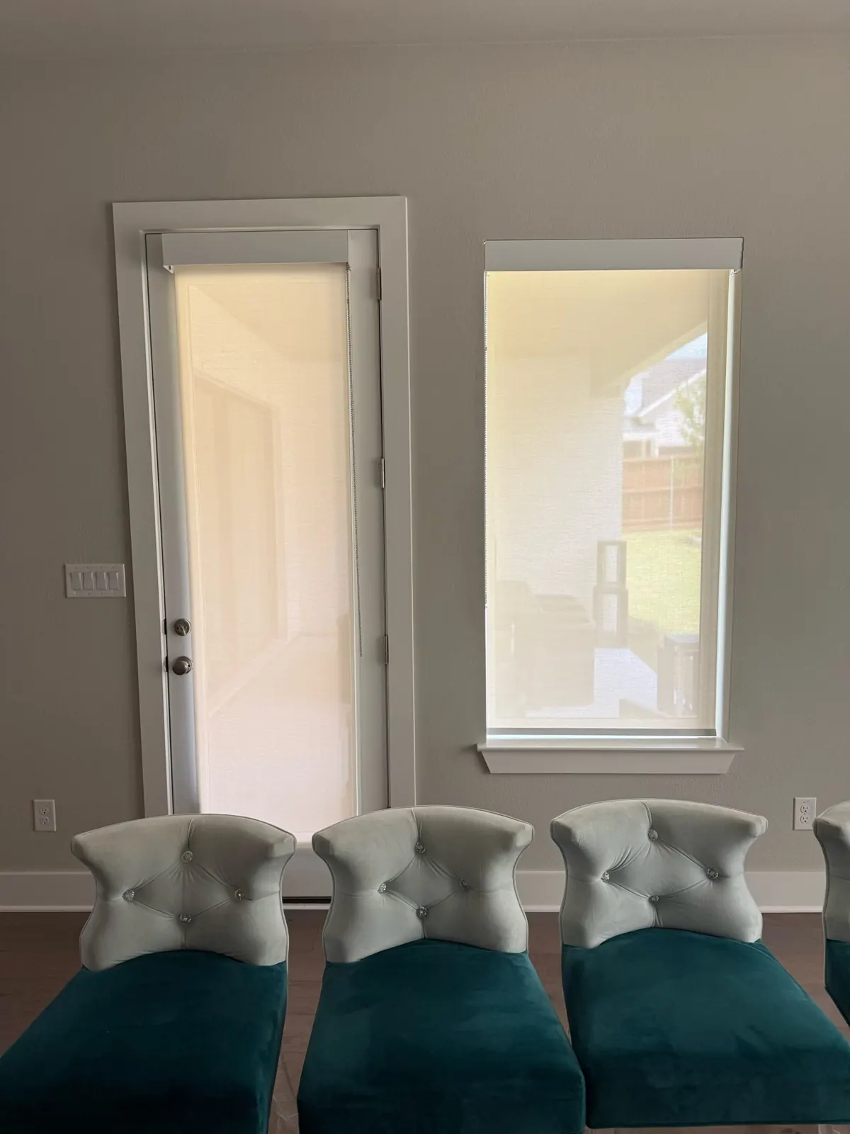 Roller shades on a patio door and window in a McKinney, TX living room